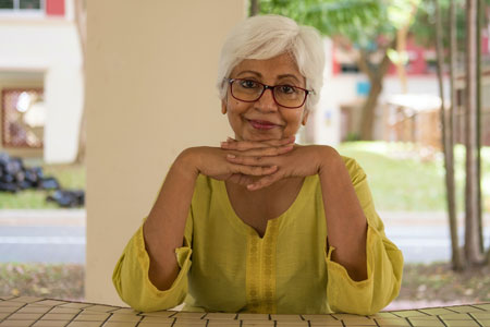 Woman sitting at a table looking at the camera